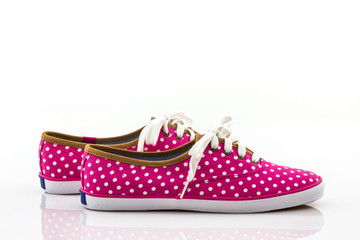 Pink polka dot canvas shoe .