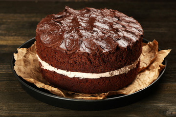 Delicious chocolate cake on table close-up