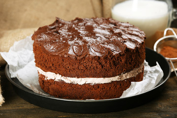 Delicious chocolate cake on table close-up