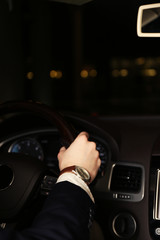 Man driving his modern car at night in city, close-up