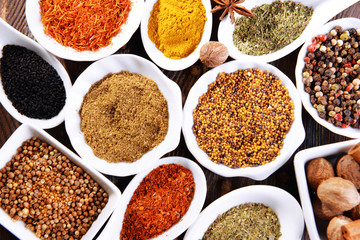 Different kinds of spices in ceramics spoons, close-up,