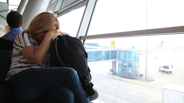 Tired woman waiting at the airport