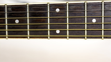 Guitar frets with strings run down the neck