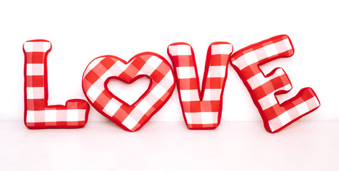 Funny love word of plush red letters on white background. Full