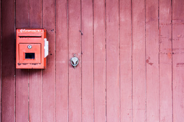 Red mailbox on the red wooden door