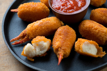 Close-up of breaded crab claws, studio shot, selective focus