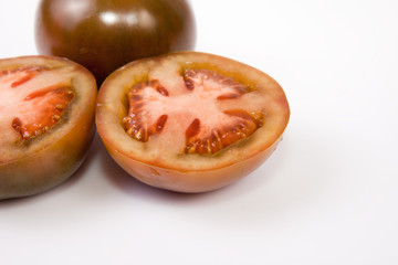 Whole and sliced kumato tomatoes
