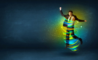 Fototapeta na wymiar Excited business man jumping with energy colourful lines
