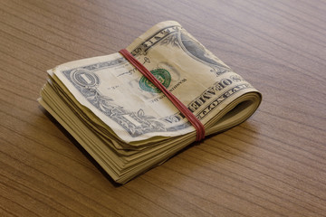 Bundle of Dollar Notes on Table