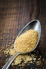 Organic amaranth grain on wood with copy space