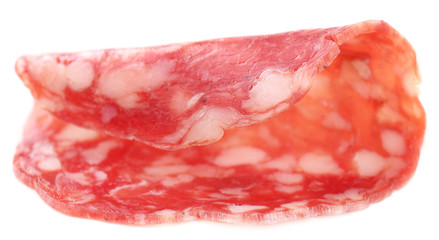 Slice of salami isolated on white background