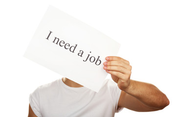 Sheet of paper with inscription I need a job in male hand