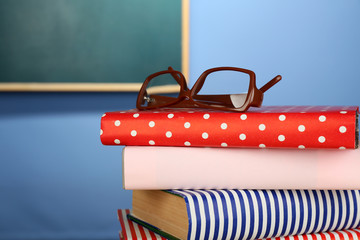 Stack of books with glasses