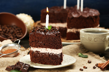 Fototapeta na wymiar Delicious chocolate cake on table on blue background