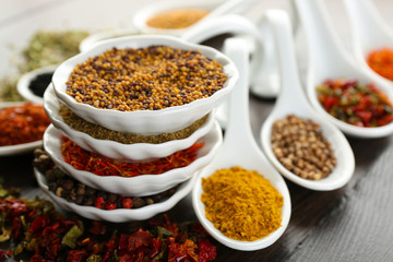 Different kinds of spices in ceramics spoons, close-up,