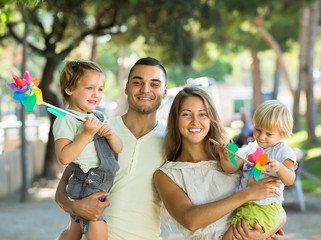 Kids with windmills on parent’s arms