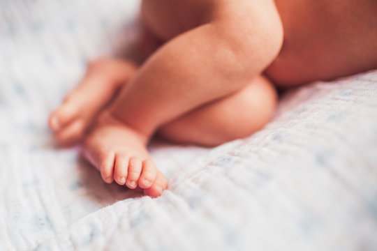 Baby feet on white blanket
