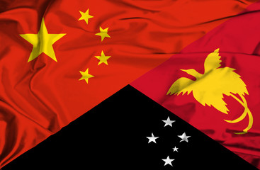 Waving flag of Papua New Guinea and China