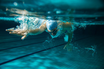 Male swimmer at the swimming pool.Underwater photo.