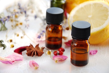 Fototapeta na wymiar essential oils with herbs and lemon