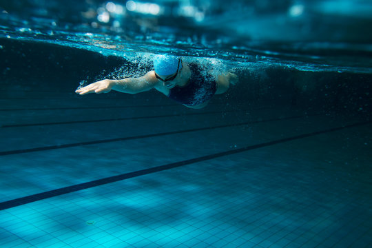 Female swimmer at the swimming pool.Underwater photo.