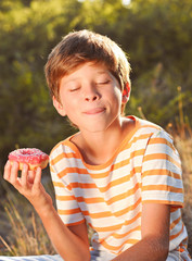 Kid boy eating donut