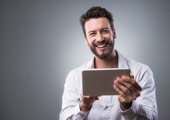 Smiling confident man with tablet