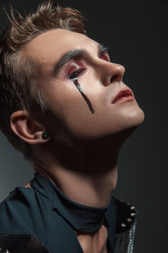 Young man  with  make  up and painted tears
