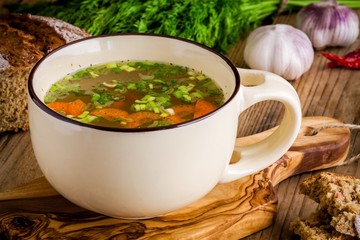 cup with vegetable soup with bread
