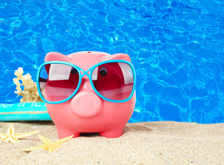 Piggy bank on beach background