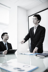 Businessman standing in front of colleagues during a meeting