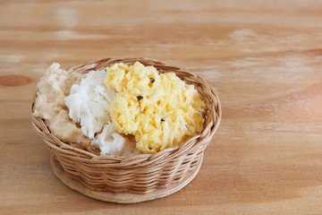 Coconut candy cocada different taste on in wicker basket on wood