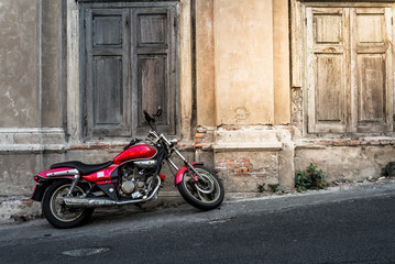 Fototapeta na wymiar Red vintage motorcycle grunge wall