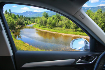 Naklejka premium landscape with river from car window