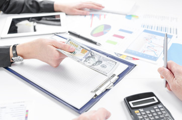 Business people exchanging dollar banknotes