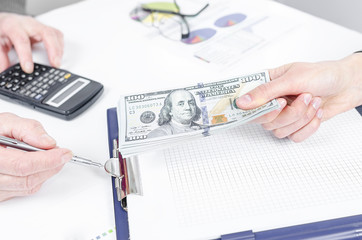 Business people exchanging dollar banknotes