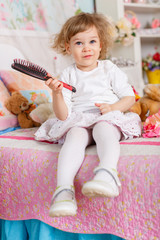 Fototapeta premium Little girl with hairbrush.
