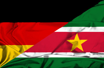 Waving flag of Suriname and Germany