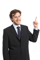 Young happy business man pointing at side and looking at camera