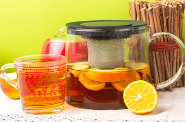 Glass teapot with black tea. Ginger tea with cinnamon