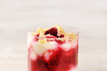 Himbeerdessert im Glas mit hellem Hintergrund