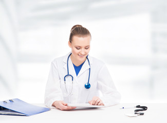 Young, professional and cheerful female doctor in the office