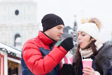 Young man giving his girlfriend a taste