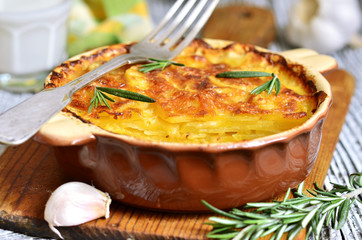 Potato slices baked in milk with cheese,garlic and herb.