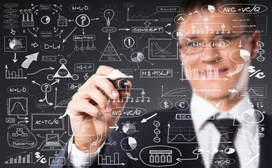 Successful and smart businessman writing imaginary text over gre