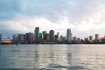 Fototapeta na wymiar Miami city skyline with bridge and cruise ship at sunset