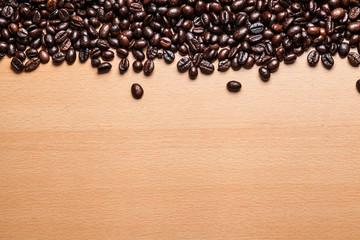 Coffee beans on wood background