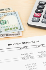 Income statement financial report with banknote and calculator