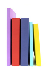 Collection of colorful paperback books in a row line isolated white background photo