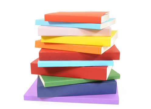 Untidy stack of colorful paperback books isolated white background photo